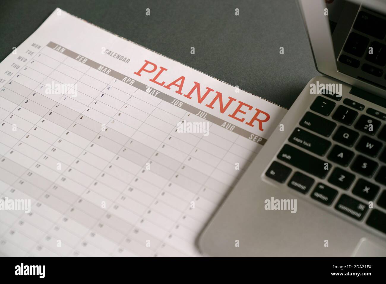 Computer laptop on top of calendar planner Stock Photo Alamy