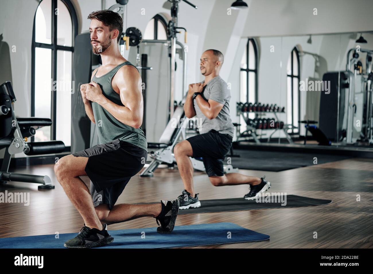 Men doing deep lunges Stock Photo Alamy
