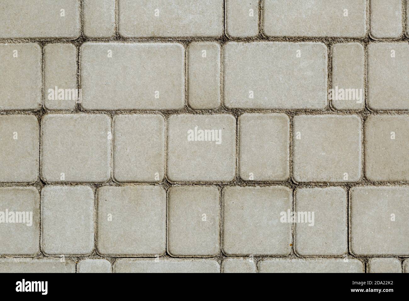 Concrete or cobble gray square pavement slabs or stones for floor, wall or path. Traditional fence, court, backyard or road paving.  Stock Photo