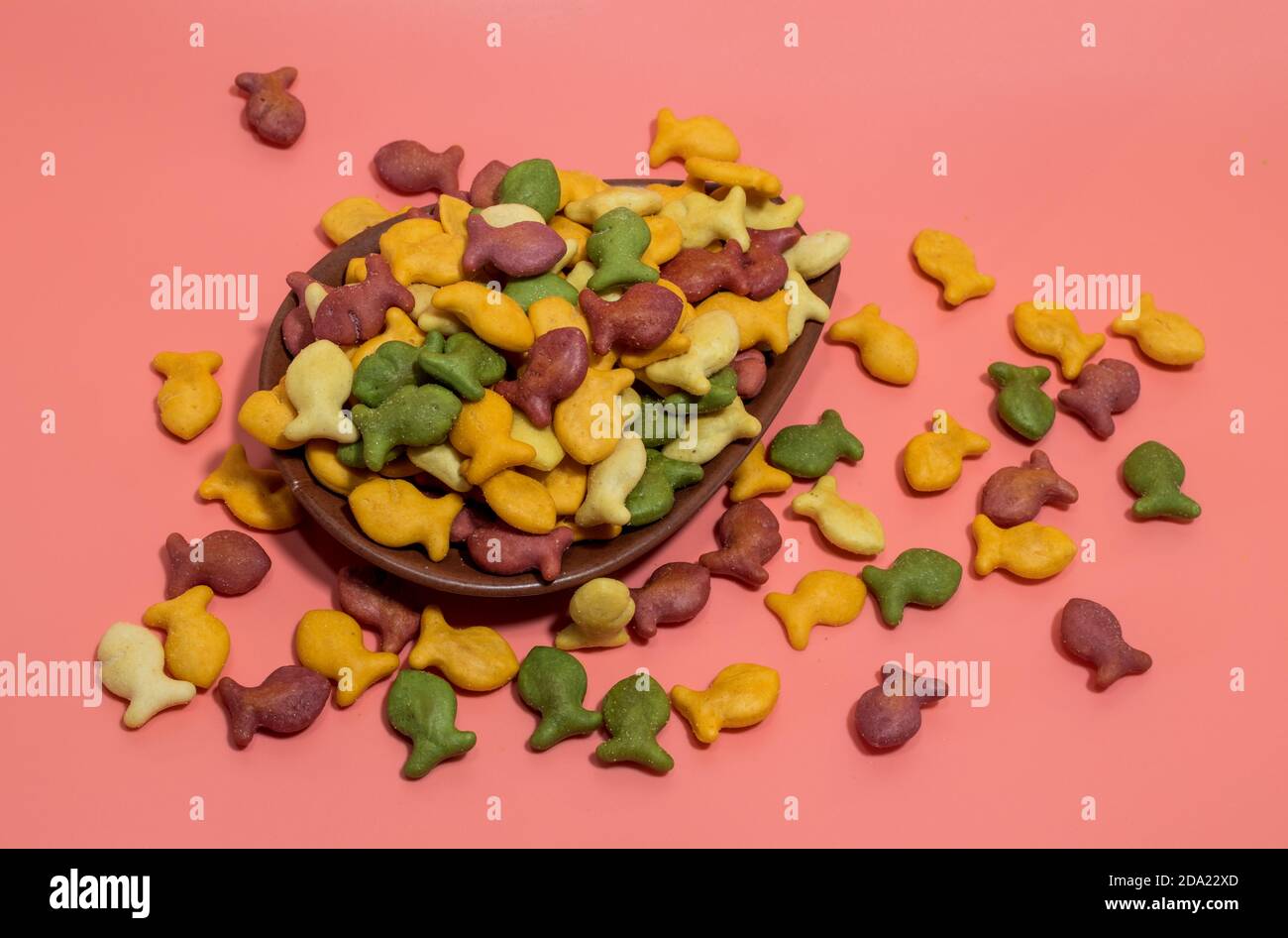 Colorful rainbow goldfish crackers on a pink background Stock Photo Alamy