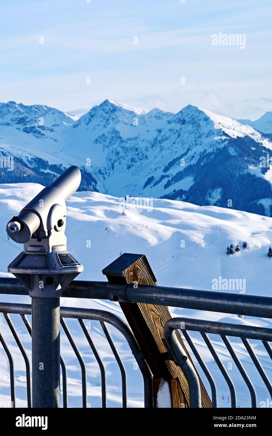 Spyglass aimed at the snowy alpine mountains. Zoom landscape in point of view Stock Photo