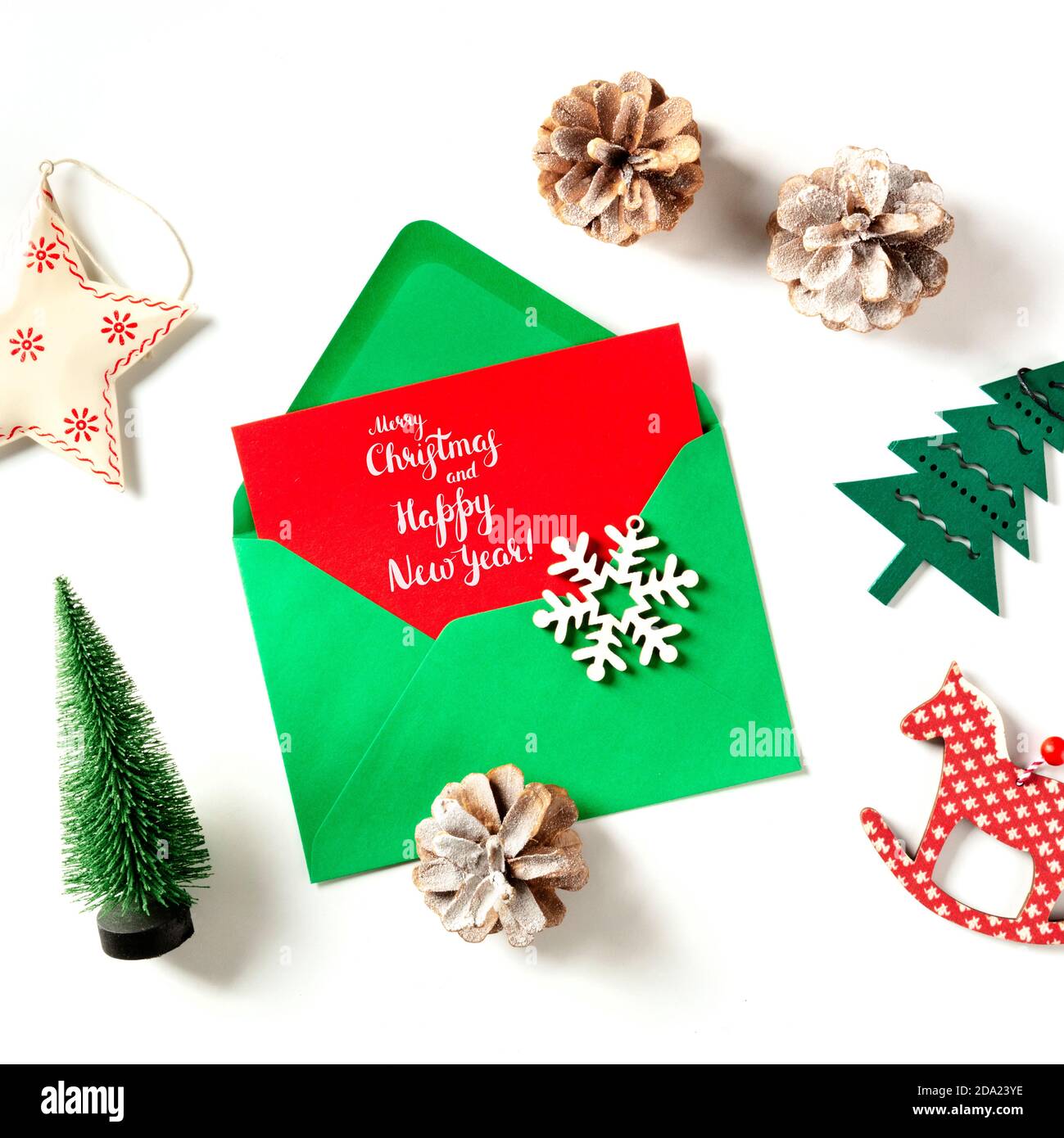 Merry Christmas and Happy New Year greeting card, shot from the top in a green envelope with holiday decorations Stock Photo