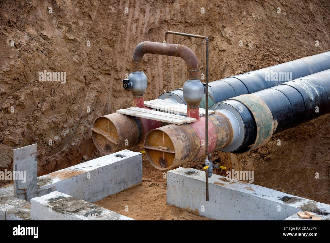 Laying heating pipes in a trench at construction site. Installation