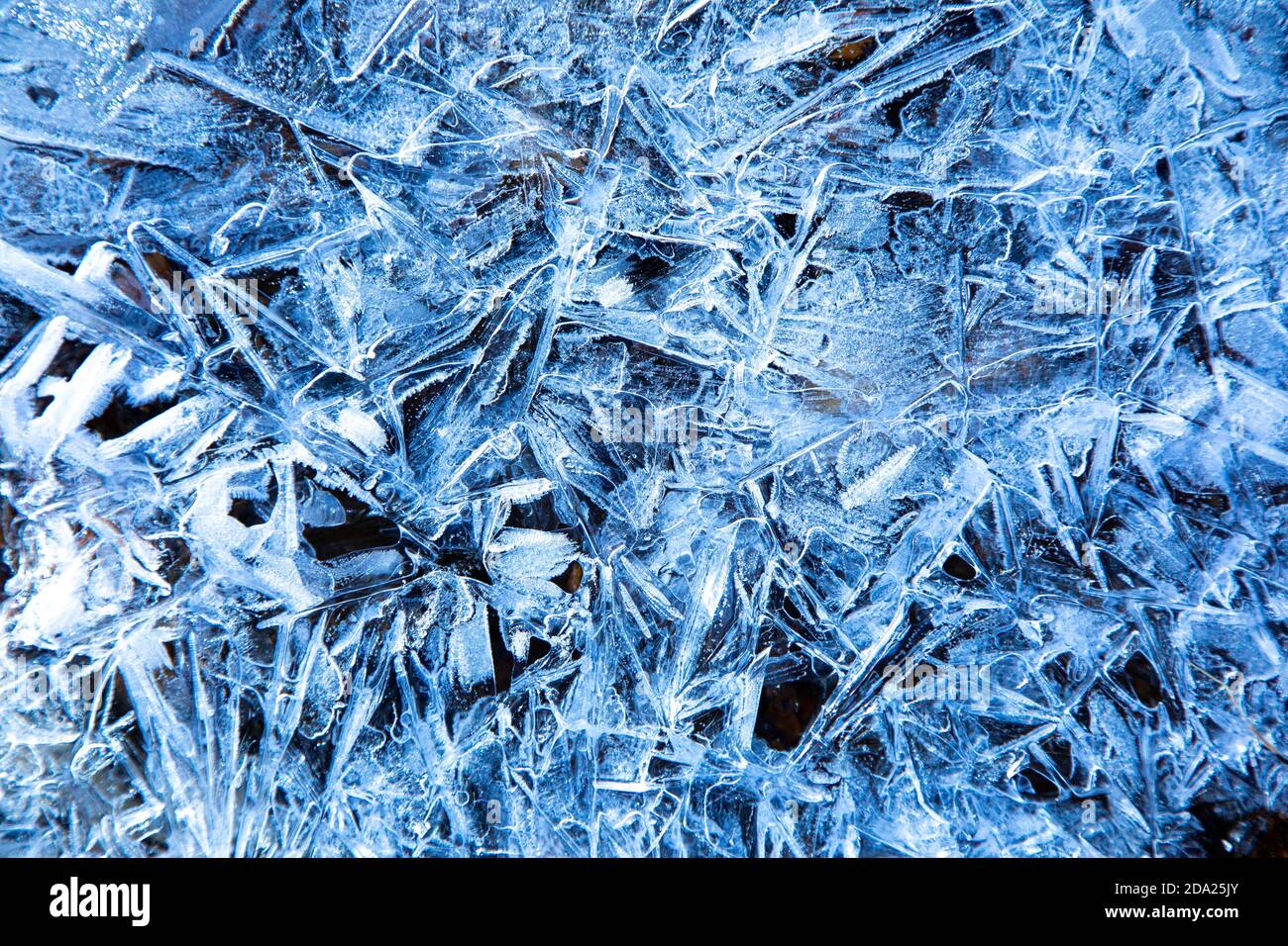 Patterns in ice of a frozen stream in the Swiss Alps Stock Photo - Alamy
