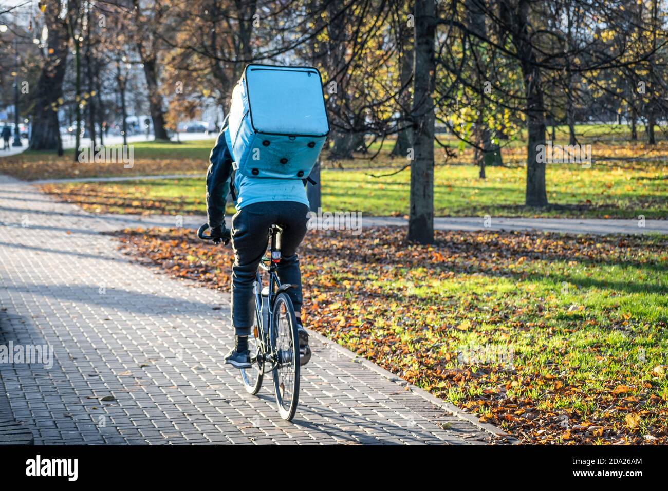 Rider with bike delivering food, online food ordering and delivery service that takes orders via a mobile app during Covid or Coronavirus time Stock Photo