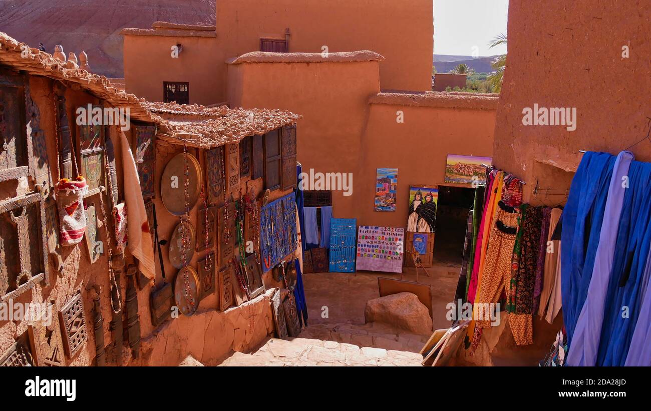 Ait Benhaddou, Morocco - 01/02/2020: Tourist souvenirs and gifts offered for sale hanging on the walls of the characteristic loam buildings . Stock Photo
