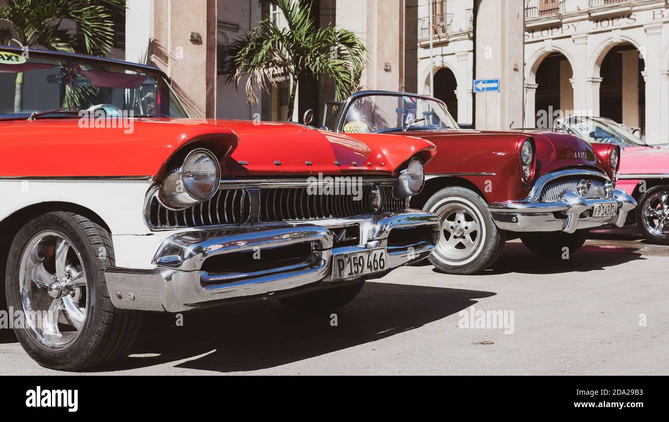 Colorful vintage American cars parked in Central Havana. Cuban taxi. Stock Photo