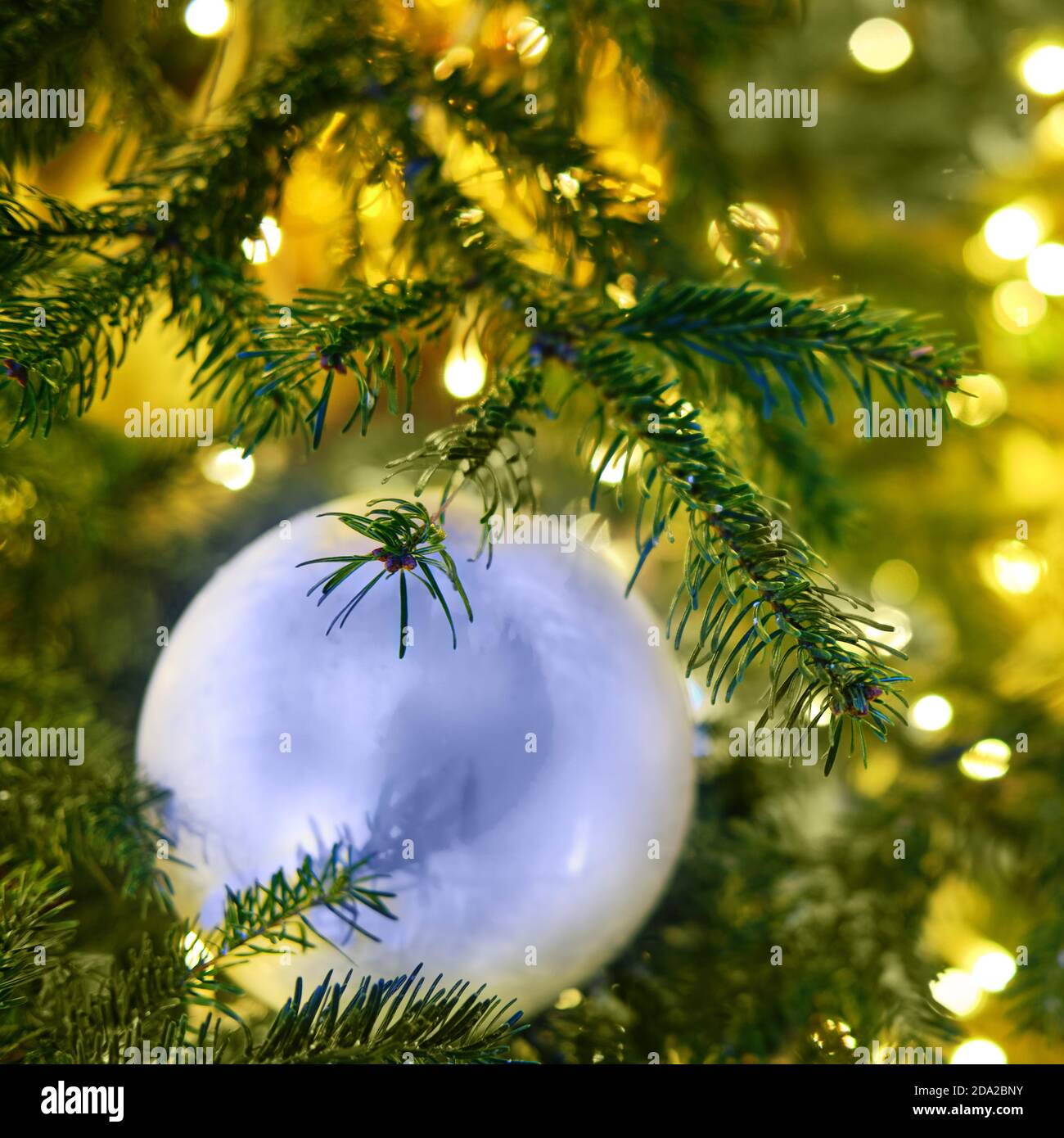 New year and green xmas tree decorations with white ball, closeup