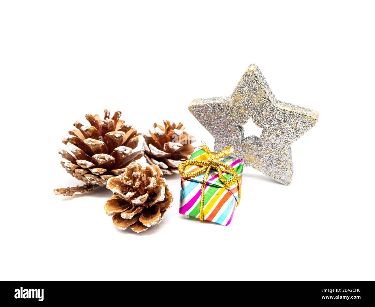 Pine cones and Christmas present isolated on white background Stock Photo