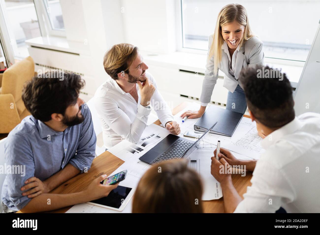 Business team people discussing documents and ideas at meeting Stock