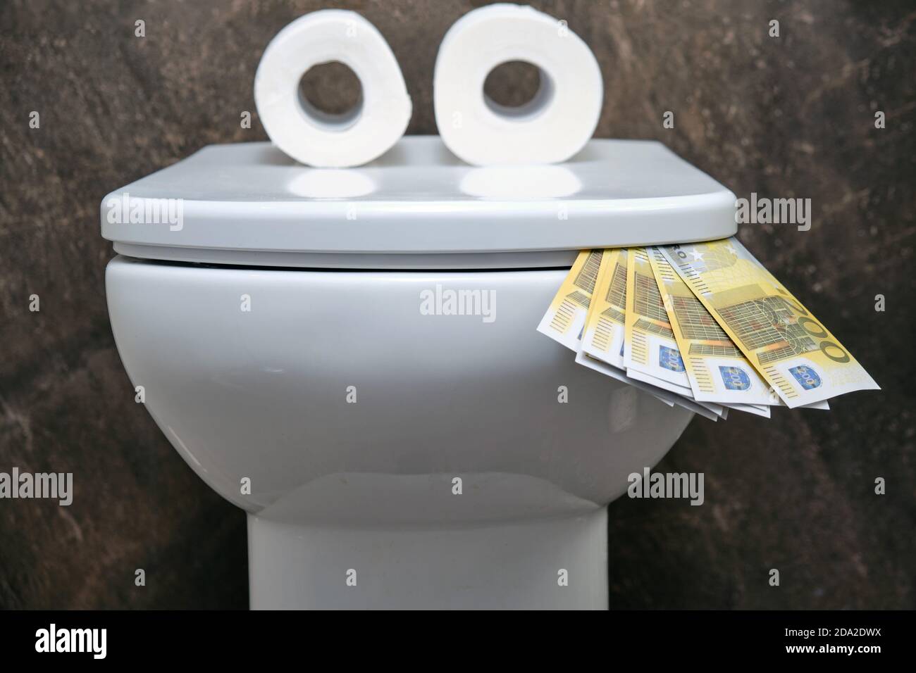Funny toilet bowl with eyes in the form of toilet paper eating money in