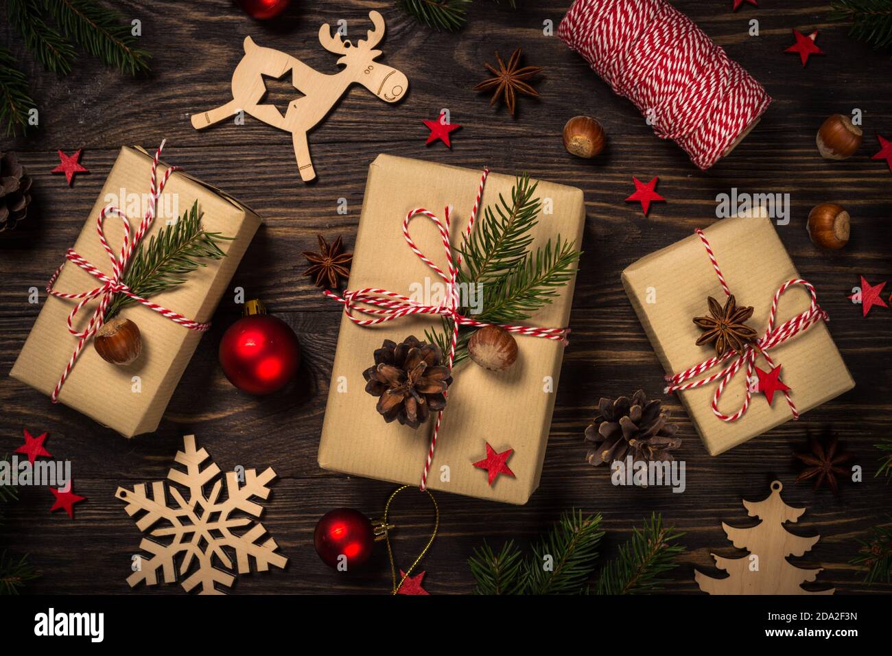 Premium Photo  Christmas organic wrapping gifts with cone pines and  brunches on wooden background