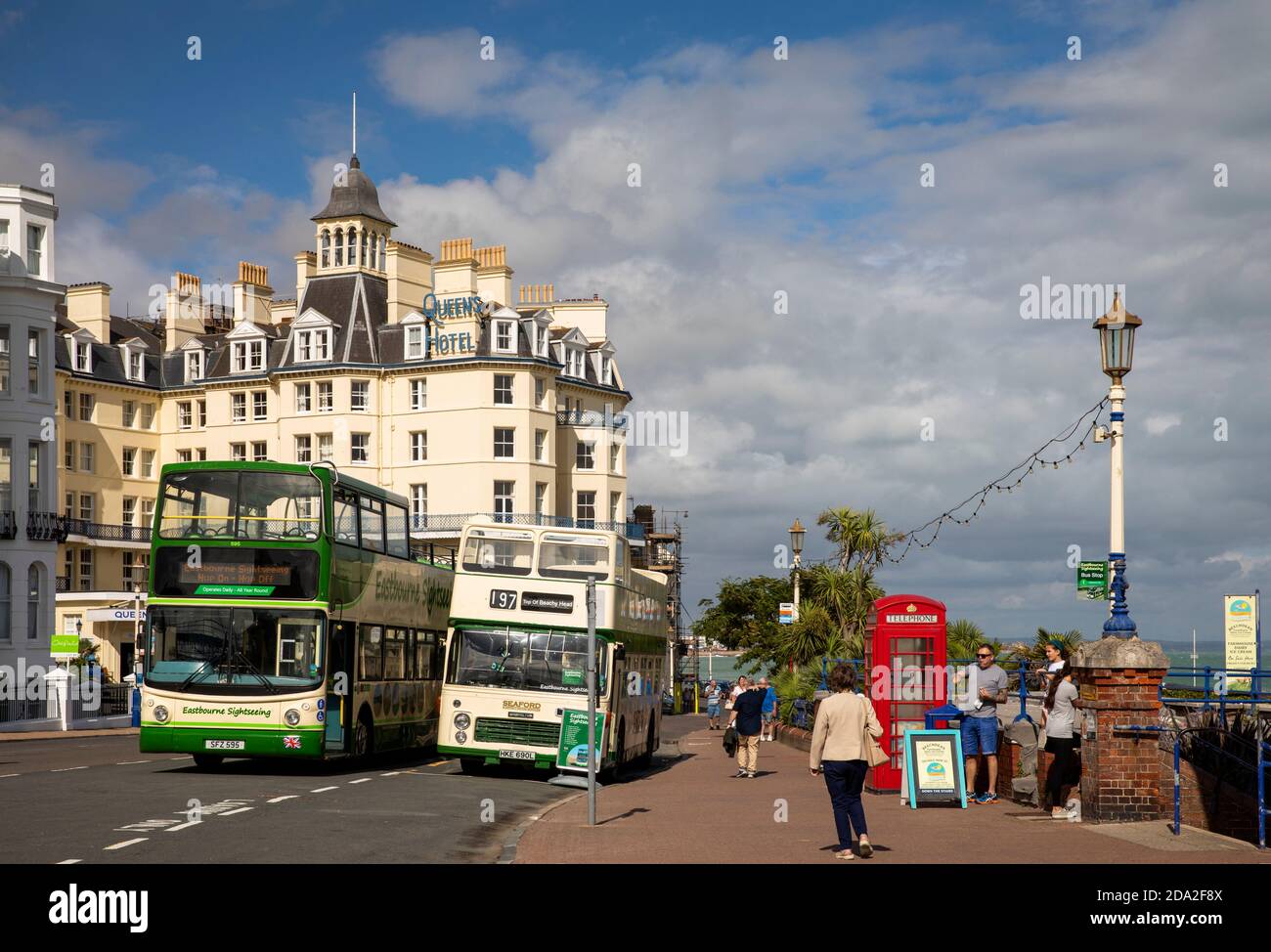 UK, England, East Sussex, Eastbourne, seafront, open topped sightseeing buses at pier stop Stock Photo