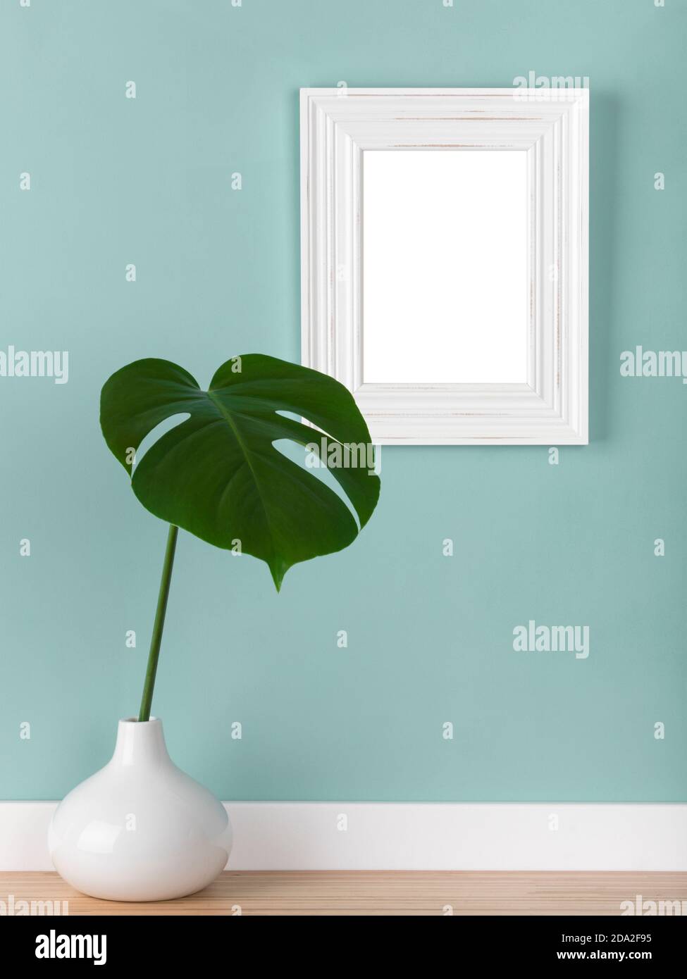Download Vertical Shabby White Picture Frame Mockup With Monstera Deliciosa Leaf In Vase In Front Of Mute Green Wall Blank Image Area Masked W Clipping Path Stock Photo Alamy