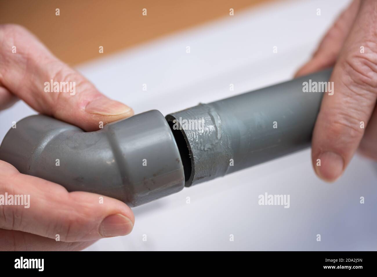 Plumber joining pvc pipe and fitting Stock Photo Alamy