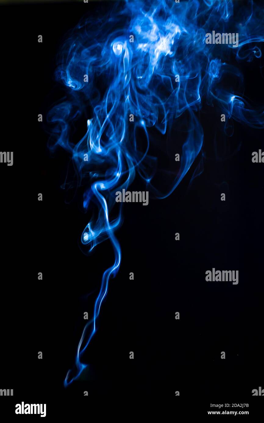 Trickle Of Vape Smoke Isolated On Black Background Swirls Of Smoke With Blue Backlight Vertical Photography For Design Stock Photo Alamy
