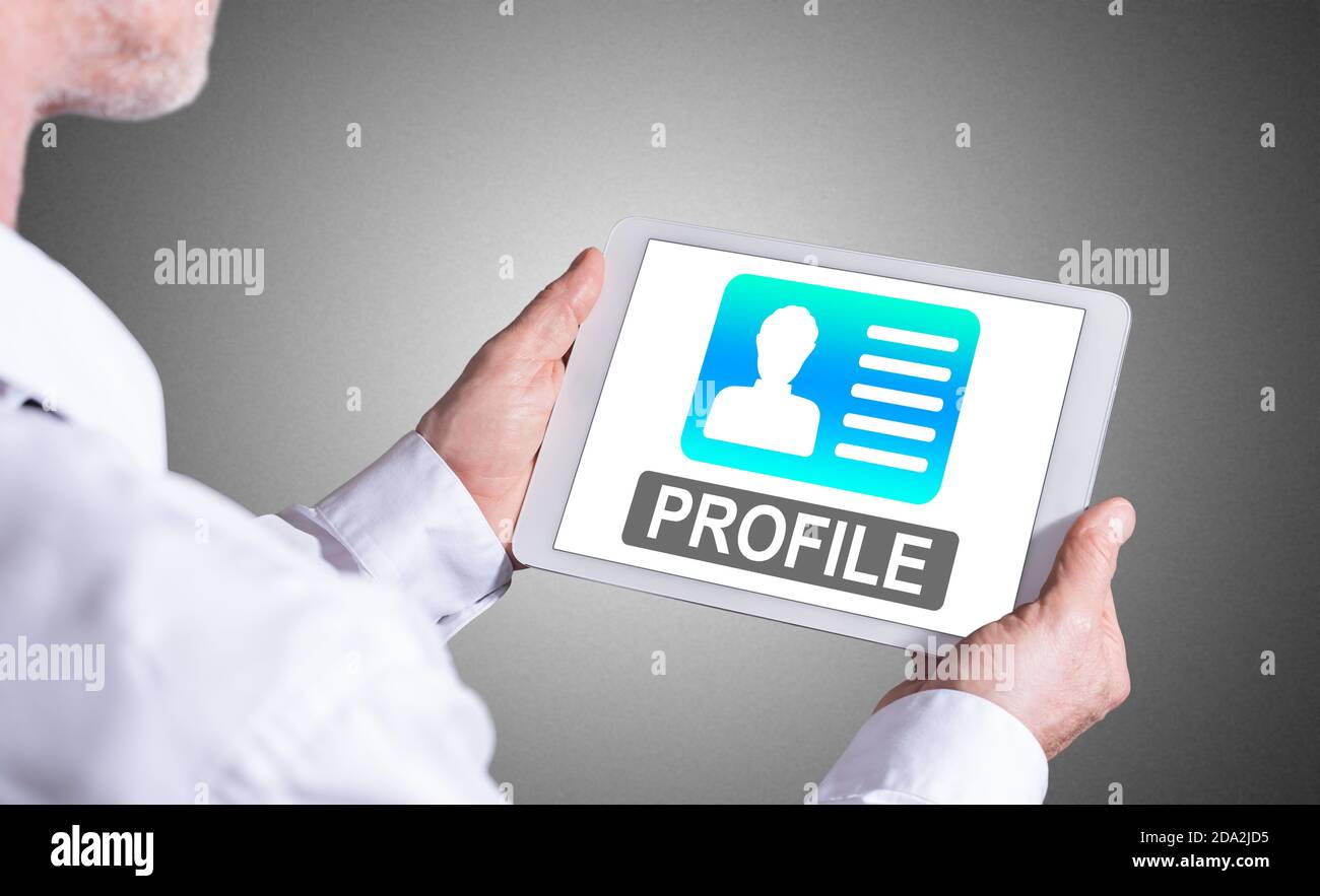 Profile Tablets Man holding a tablet showing profile concept Stock Photo - Alamy
