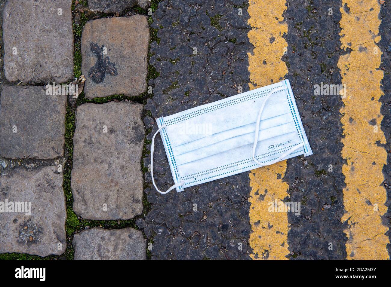 Windsor, Berkshire, UK. 7th November, 2020. The familiar sight of a discarded face mask. Windsor was much busier today on the third day of the new Covid-19 Coronavirus lockdown. A lot more shops and cafes were open than during the first lockdown. Credit: Maureen McLean/Alamy Stock Photo