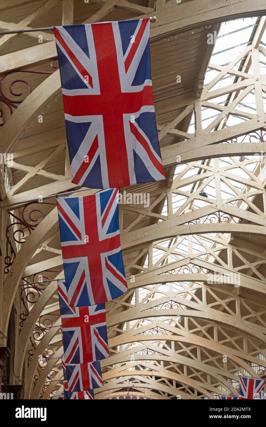Line of Union Jack flags adorning an indoor market hall Stock Photo