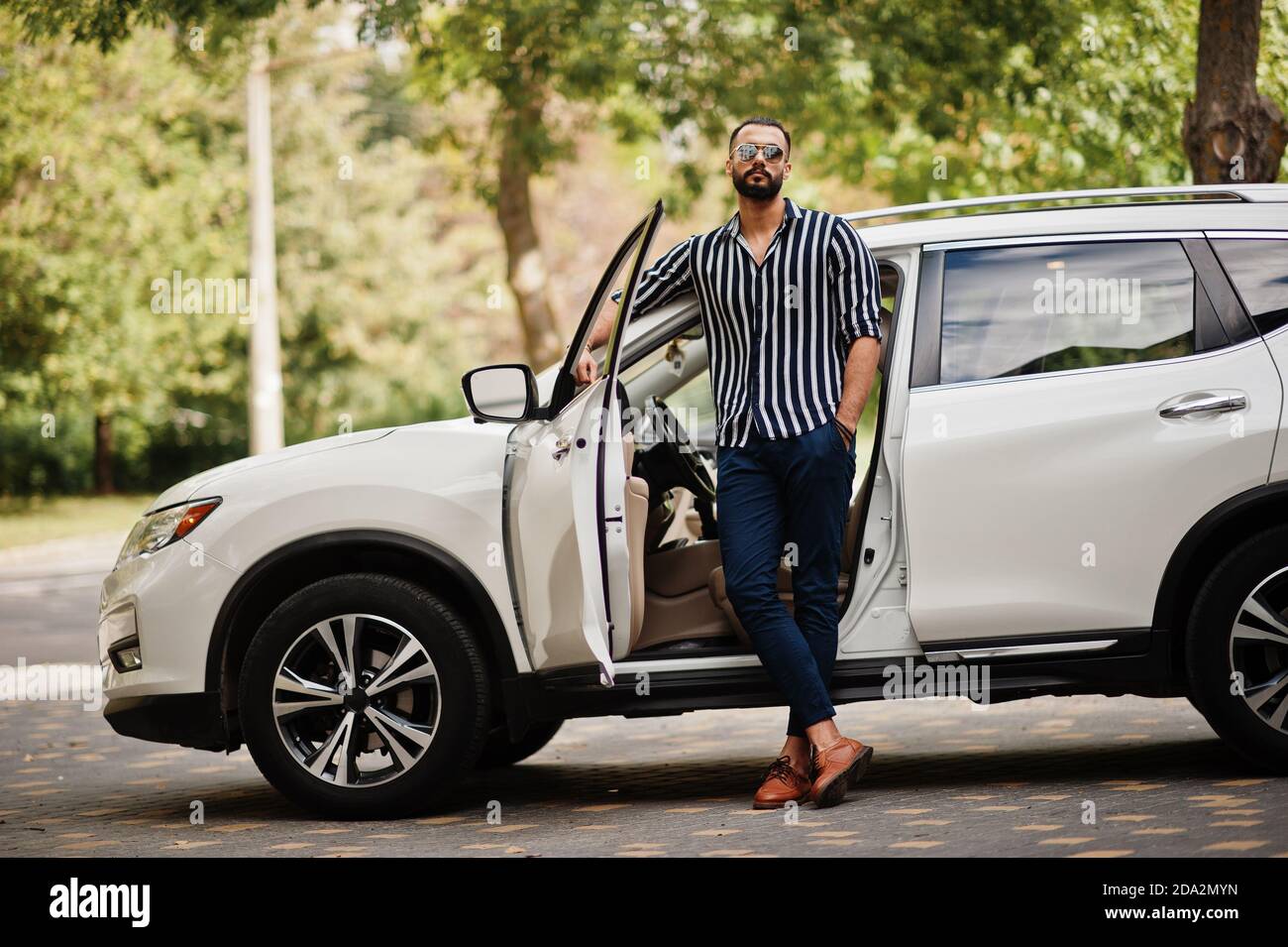 Premium Photo | Solid asian man in white shirt and sunglasses posed near  black mafia suv cars