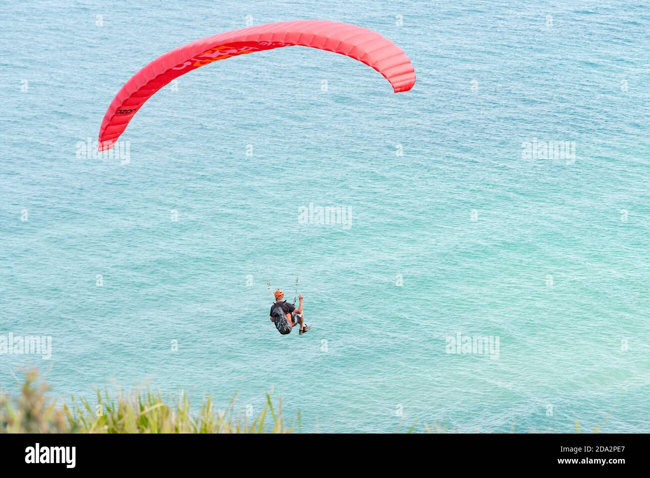 Looking down to a paraglider flying from the popular launch point of Bald Hill, Stanwell Tops, New South Wales, Australia Stock Photo