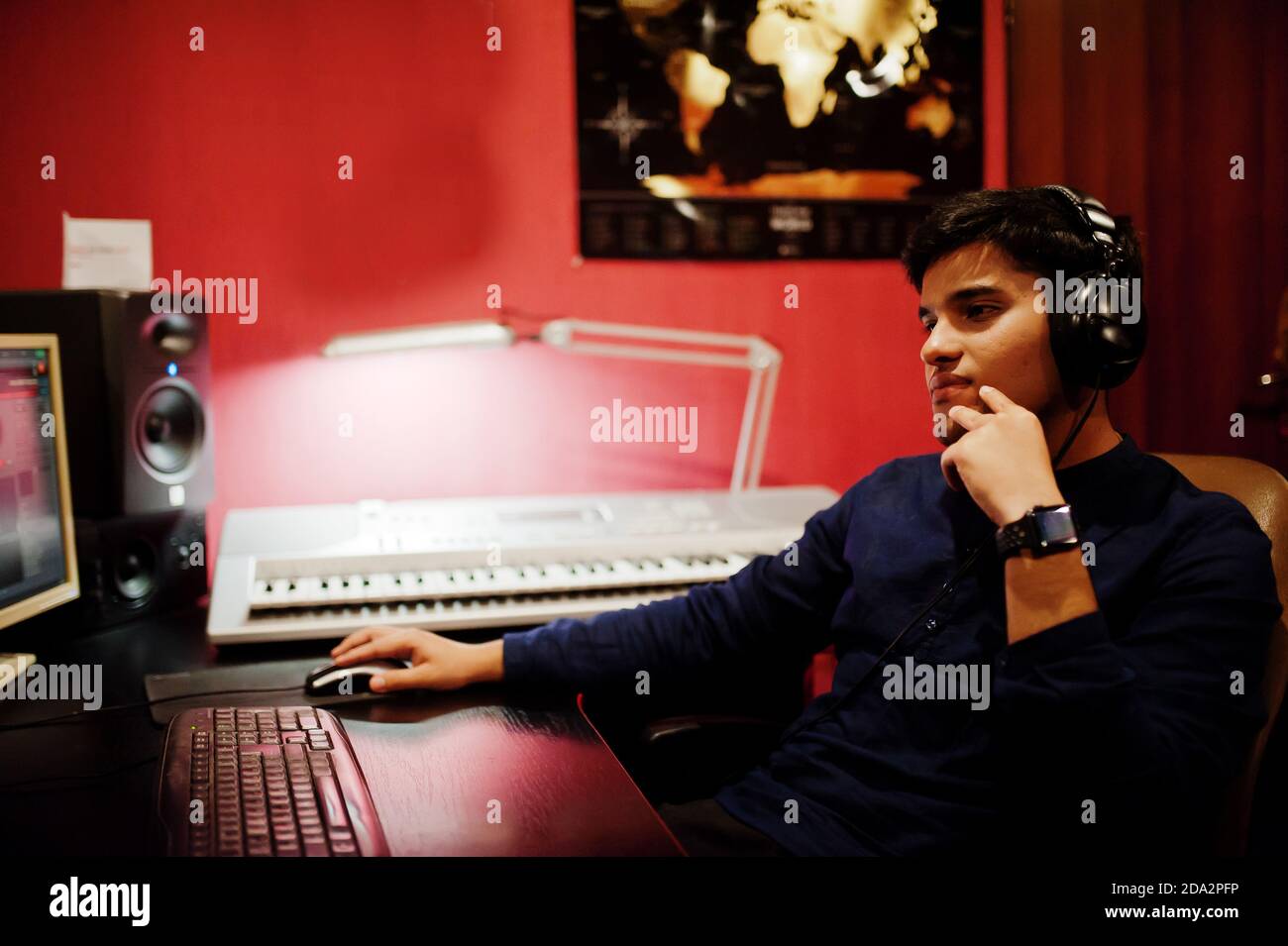 Young asian singer with microphone recording song in record music ...