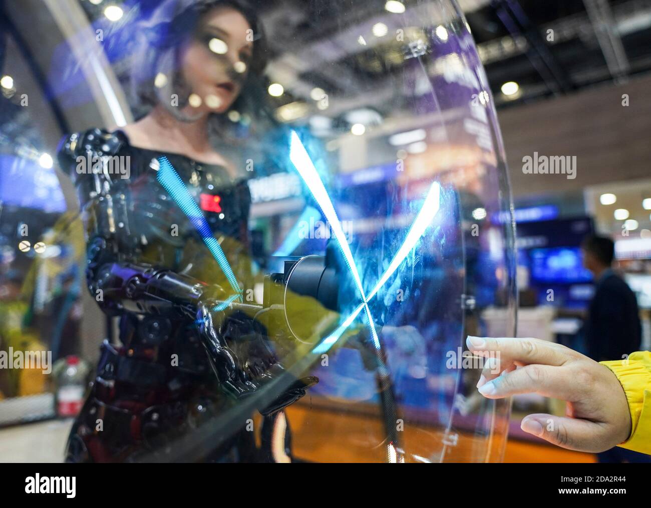 Shanghai, China. 9th Nov, 2020. A visitor interacts with a bionic android  from EXROBOTS at the Intelligent Industry and Information Technology  exhibition area during the third China International Import Expo (CIIE) in