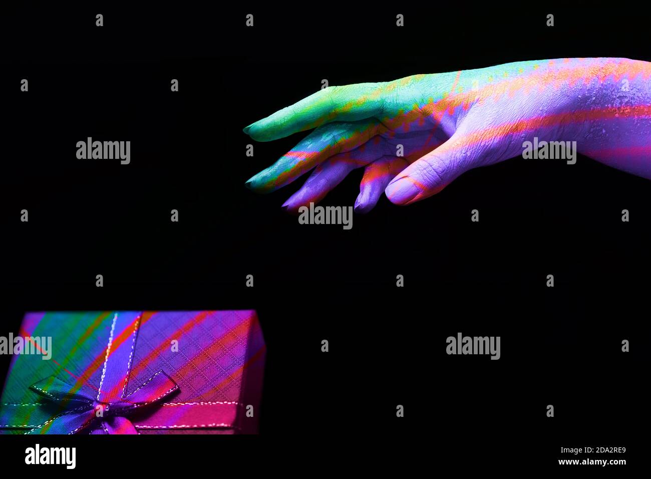 A beautiful female hand with different colours wants to take a color ...
