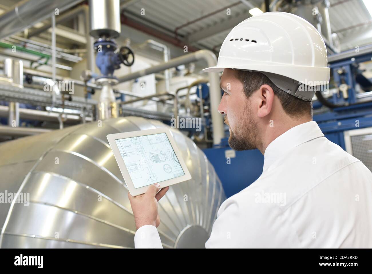 businessman checking factory interior in an industrial plant Stock Photo