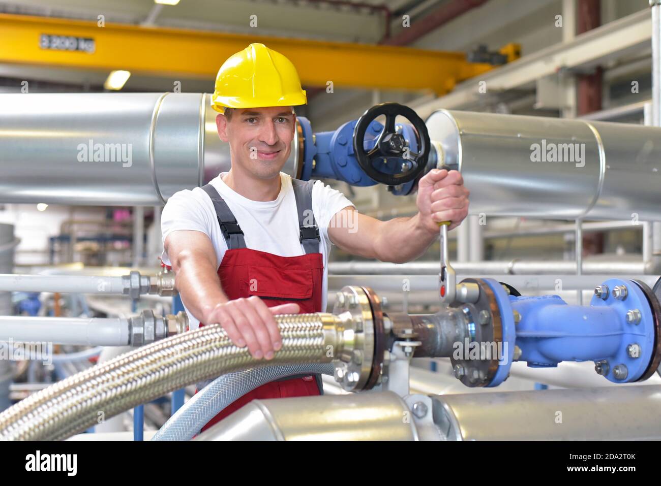 Mechanics repair a machine in a modern industrial plant - profession and teamwork Stock Photo
