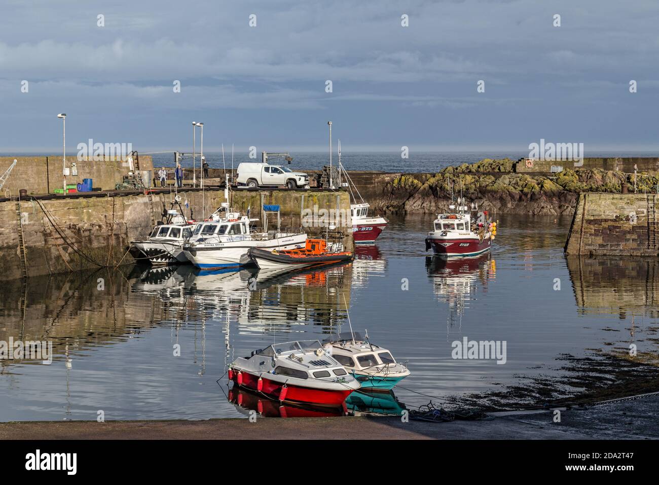 Fishing boats in St Abbs harbour, a small fishing village near Coldingham in Berwickshire, Scotland Stock Photo