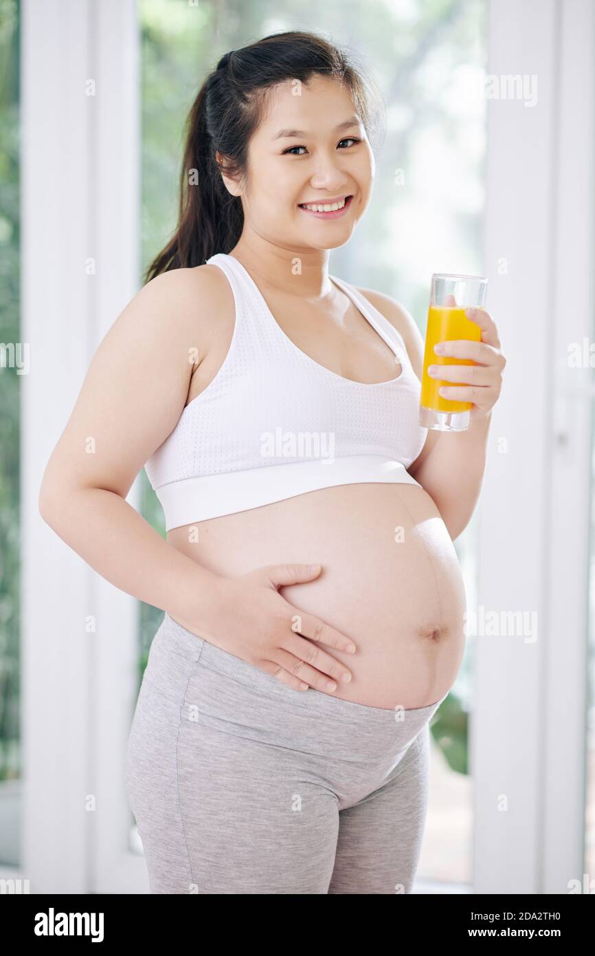 Pregnant woman drinking orange juice Stock Photo Alamy