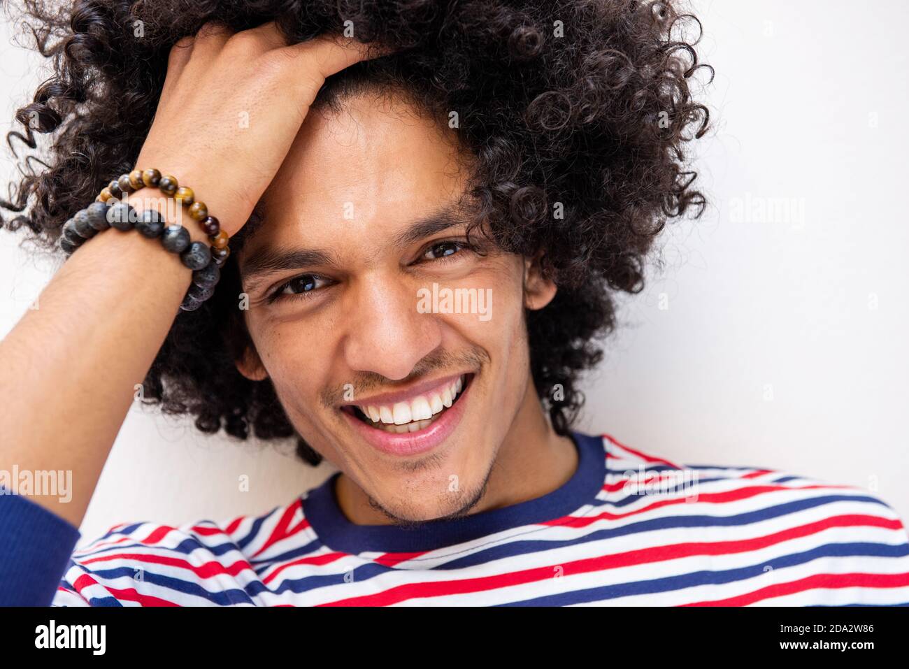 Close up portrait smiling arabic male fashion model with hand in hair Stock  Photo - Alamy