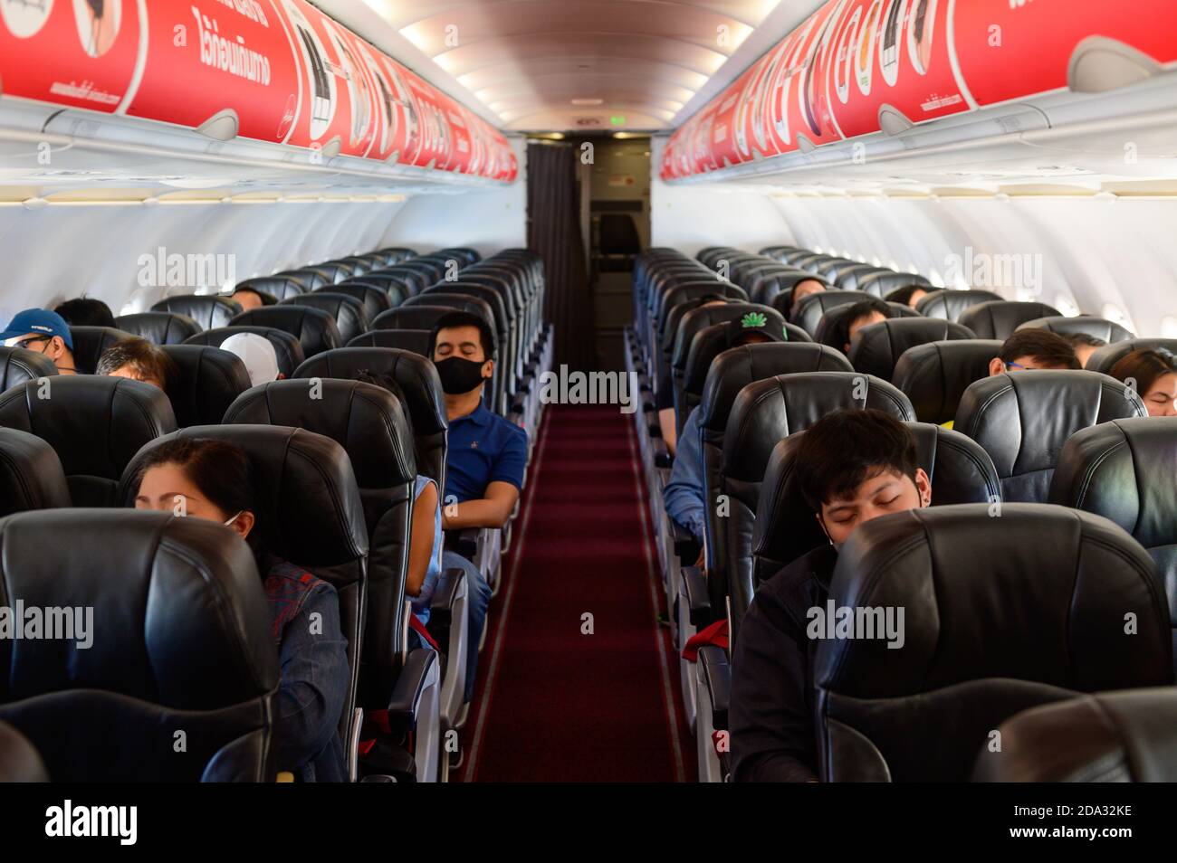 Passengers wear surgical mask inside Thai Air Asia airplane due to