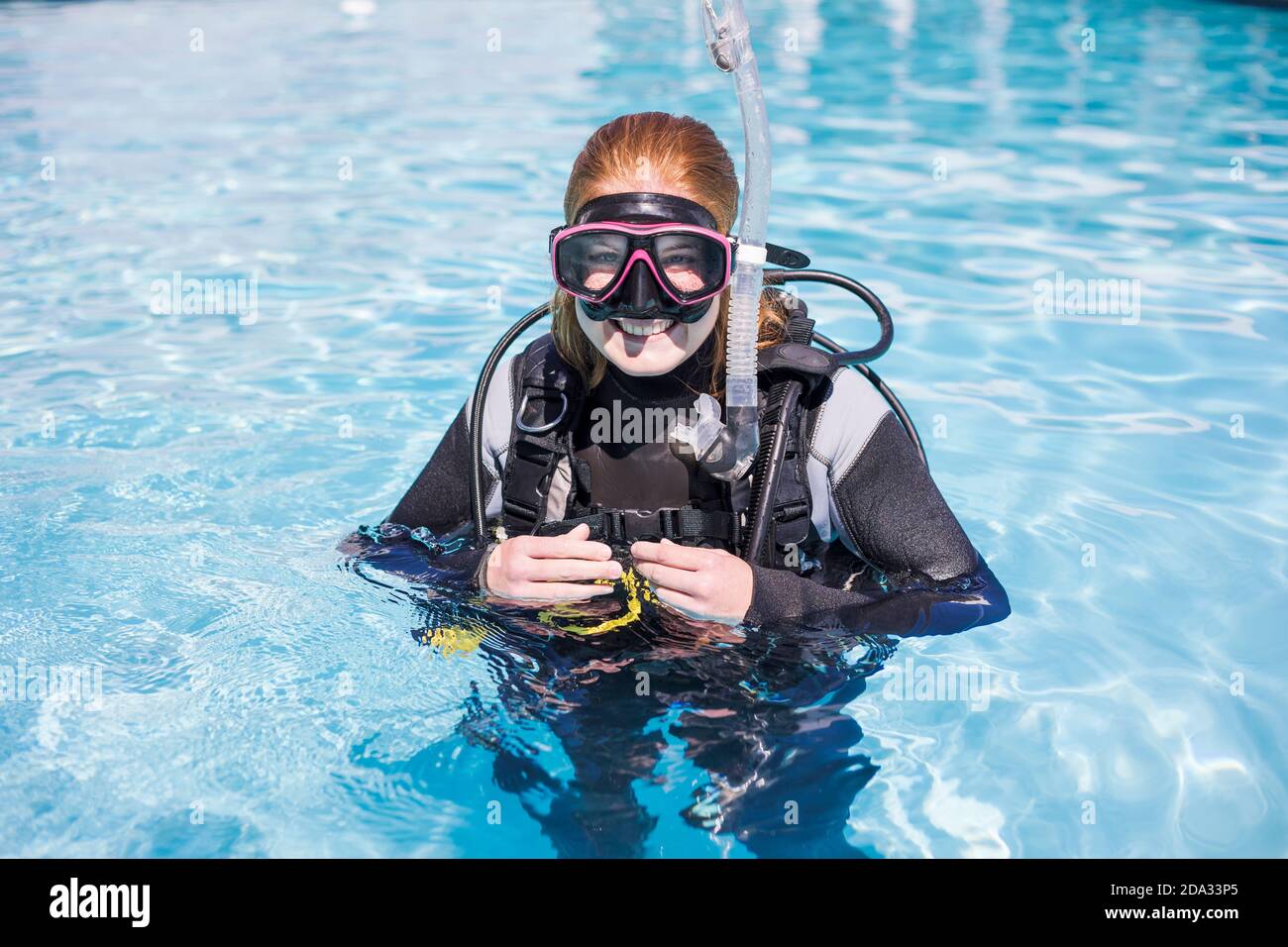 Scuba dive training in a pool with diver looking at the camera with a dive mask on smiling Stock Photo