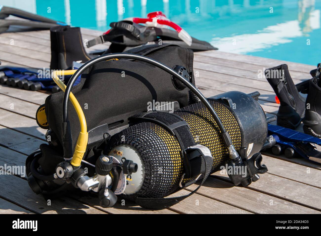 Scuba diving gear laying next to a training pool ready to be used Stock