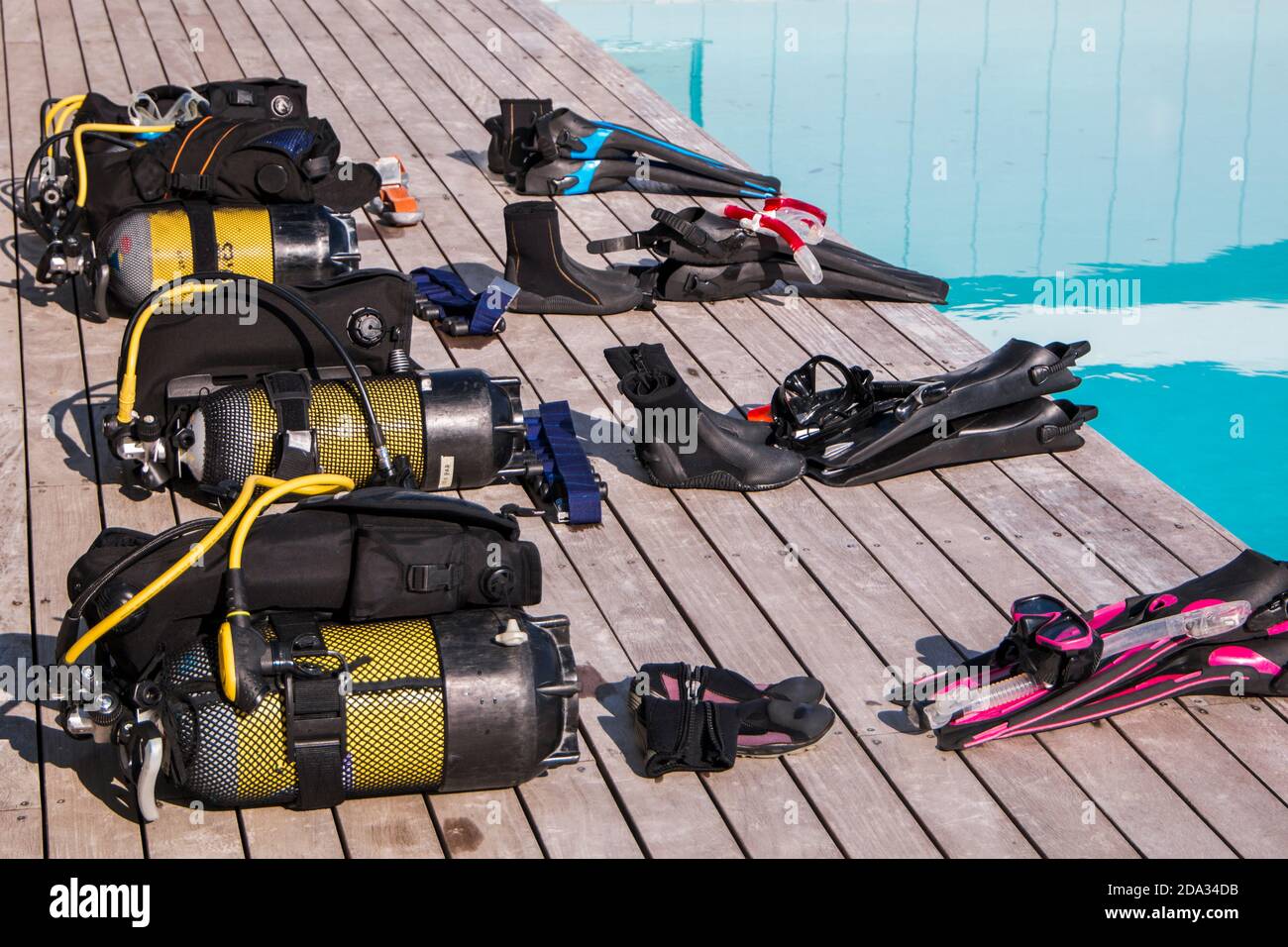 Scuba diving gear laying next to a training pool ready to be used Stock
