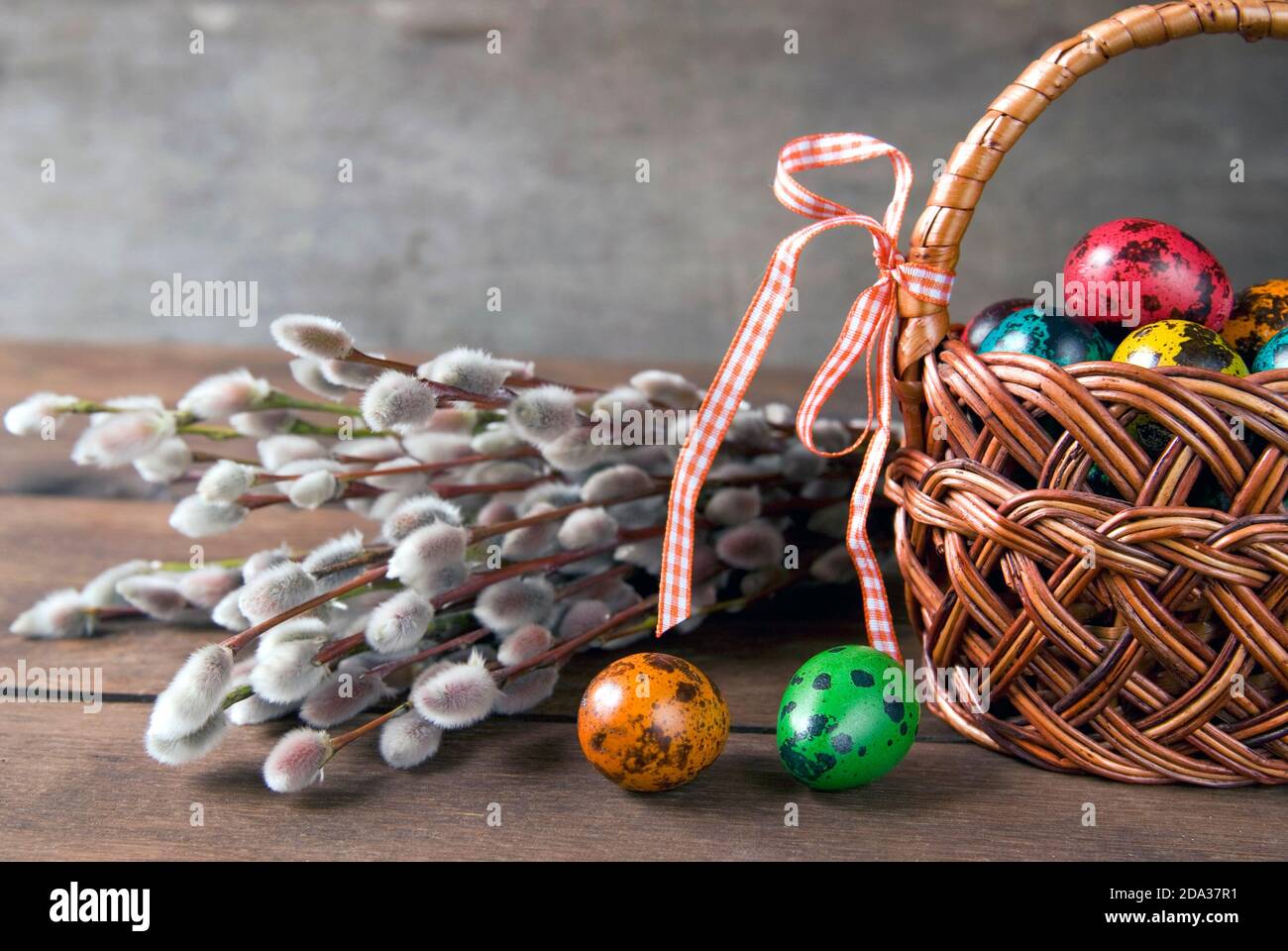 Wicker basket with Easter eggs and willow twigs bouquet Stock Photo - Alamy