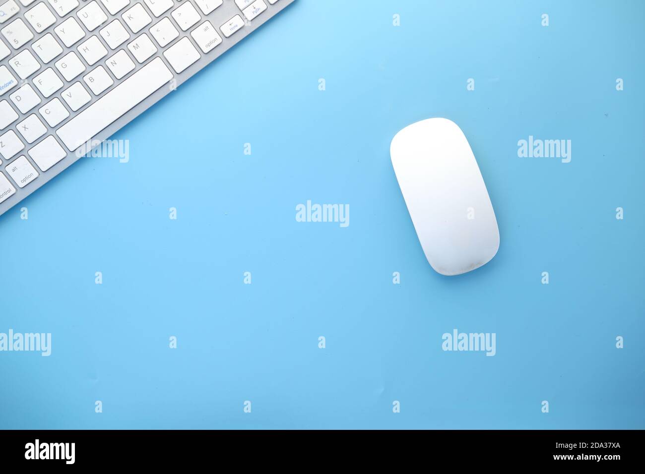 Top view of computer mouse, keyboard on blue background, Stock Photo