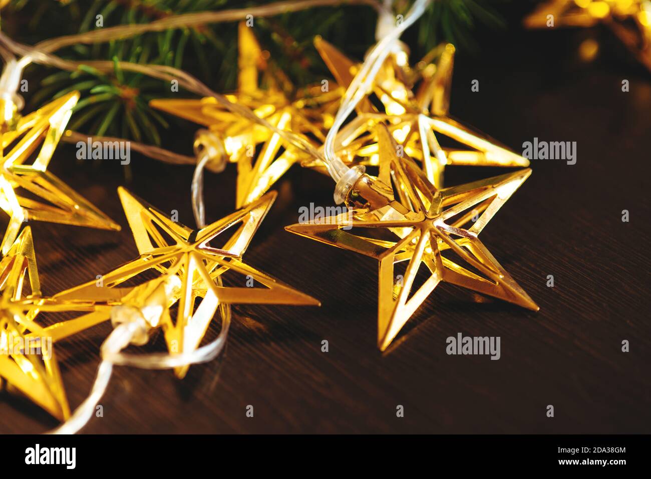 Christmas tree branch and garland Stock Photo - Alamy