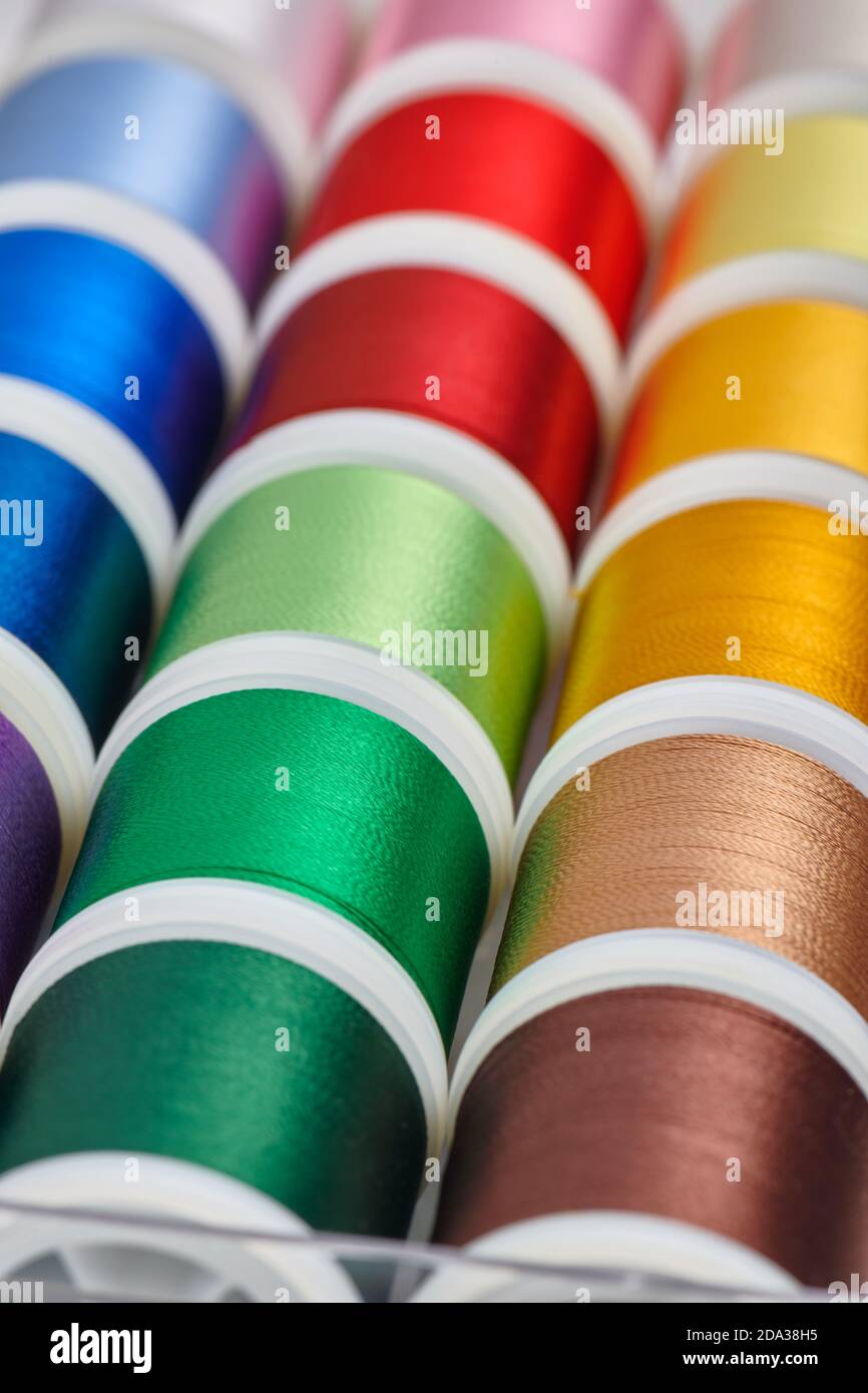 Background from spools with multicolored sewing threads Stock Photo