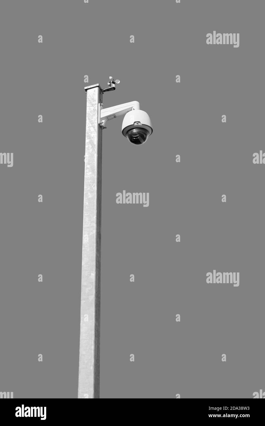 Security camera on white pole, isolated on grey background Stock Photo