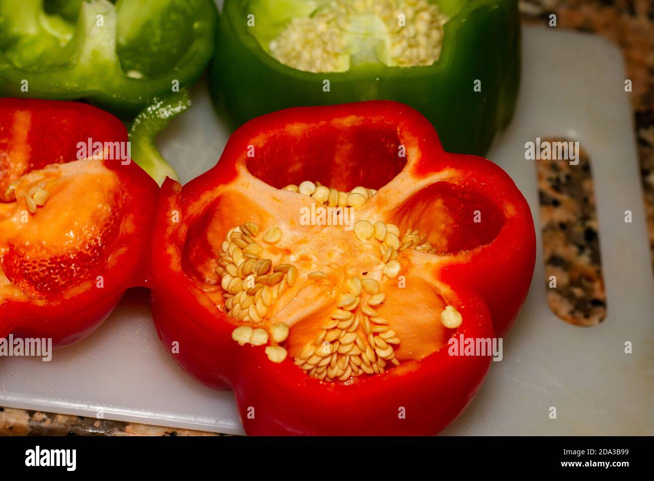 Closeup shot of green and red bell peppers cut in half Stock Photo - Alamy
