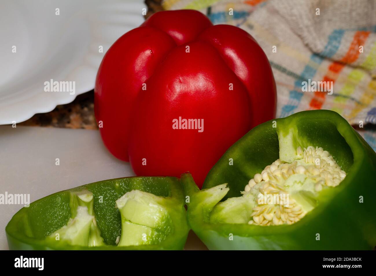 Closeup shot of green and red bell peppers cut in half Stock Photo - Alamy