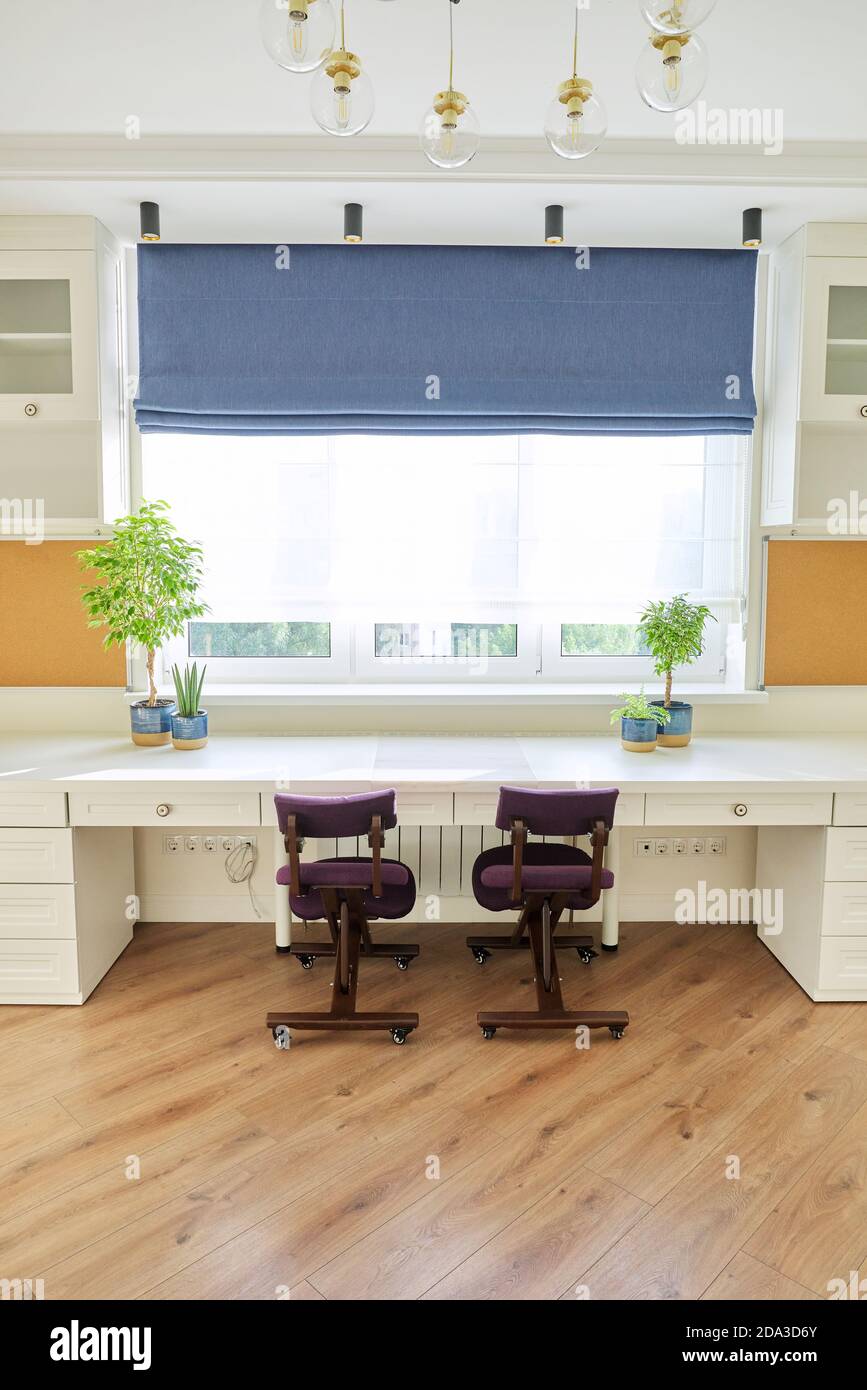 Home office, workplace for two people, desk near the window Stock Photo