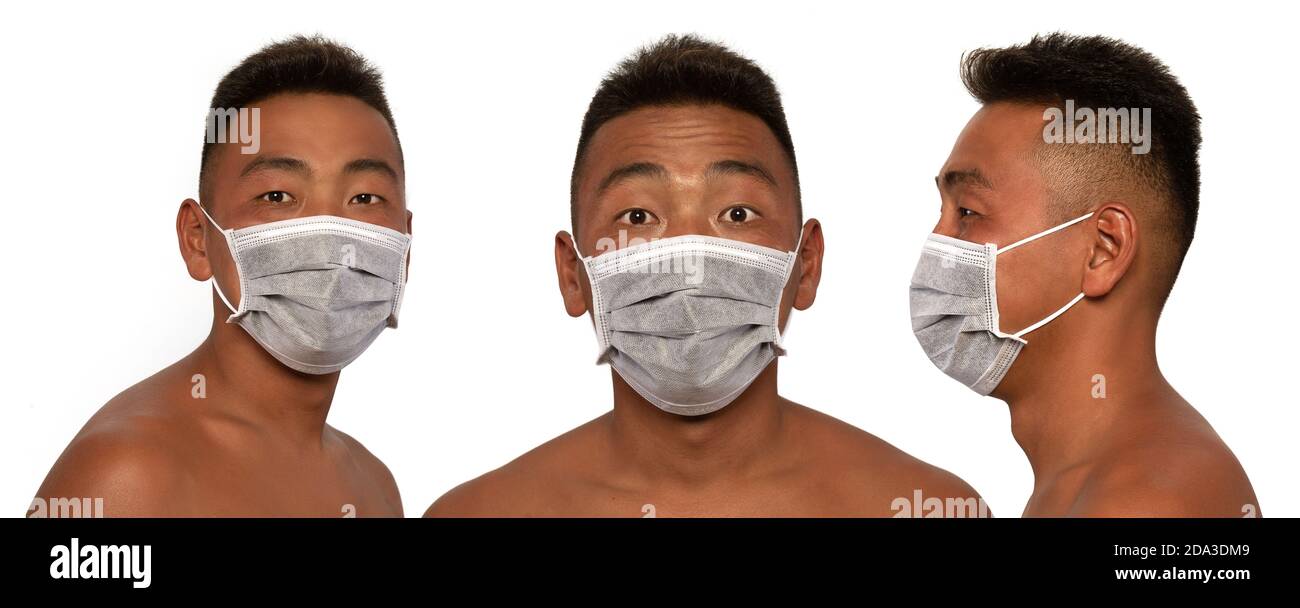The young Asian man is wearing a medical mask. Isolated on white ...
