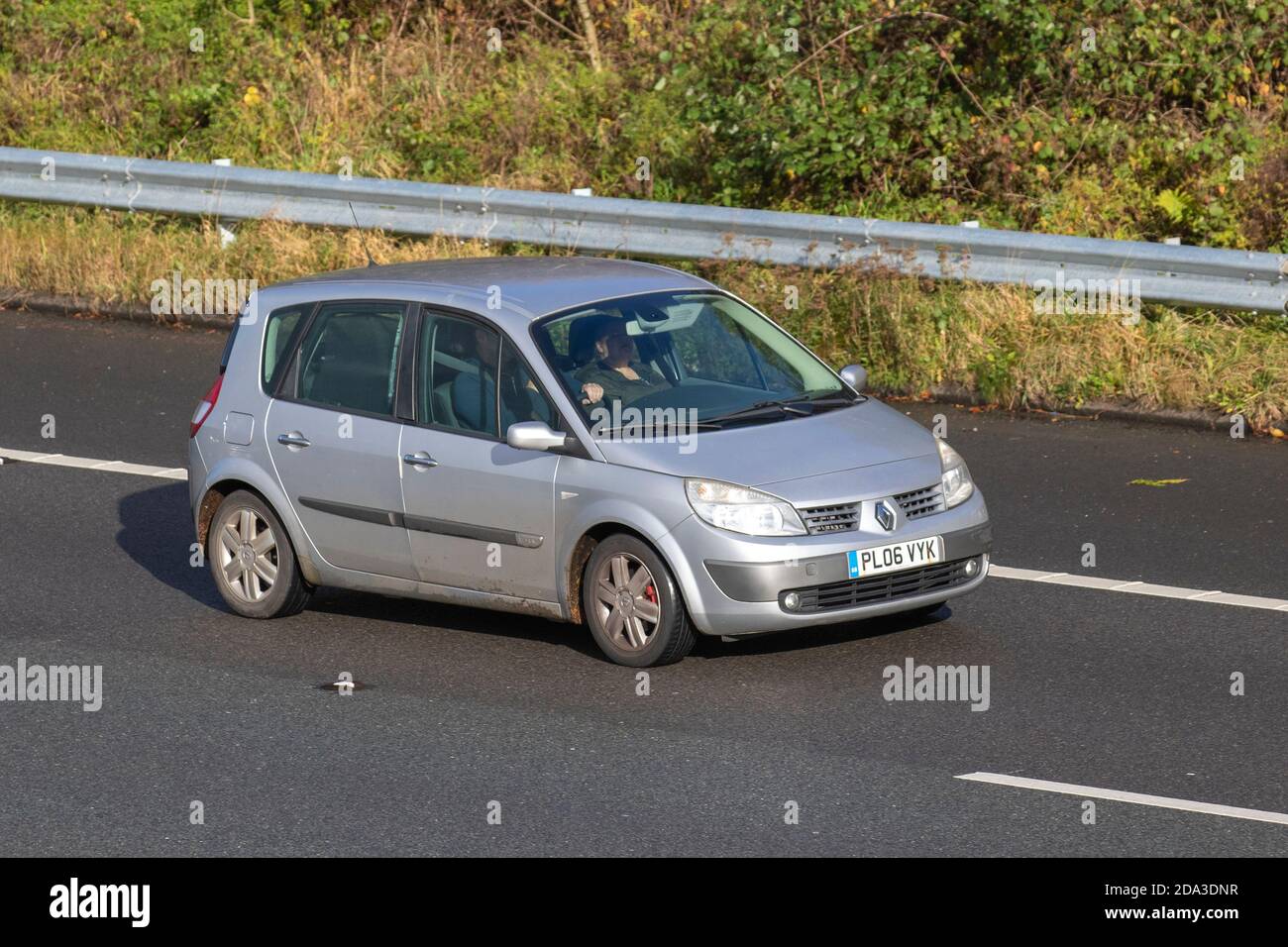 2006 silver Renault Scenic Dynamique VVT; Vehicular traffic, moving vehicles, cars, vehicle driving on UK roads, motors, motoring on the M6 motorway highway UK road network. Stock Photo