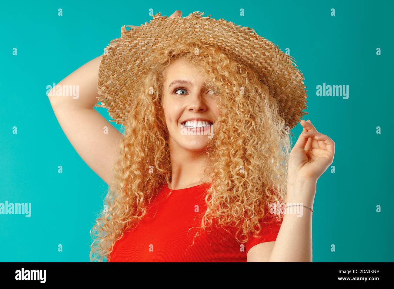 Beautiful blonde woman model posing in a straw hat Stock Photo - Alamy
