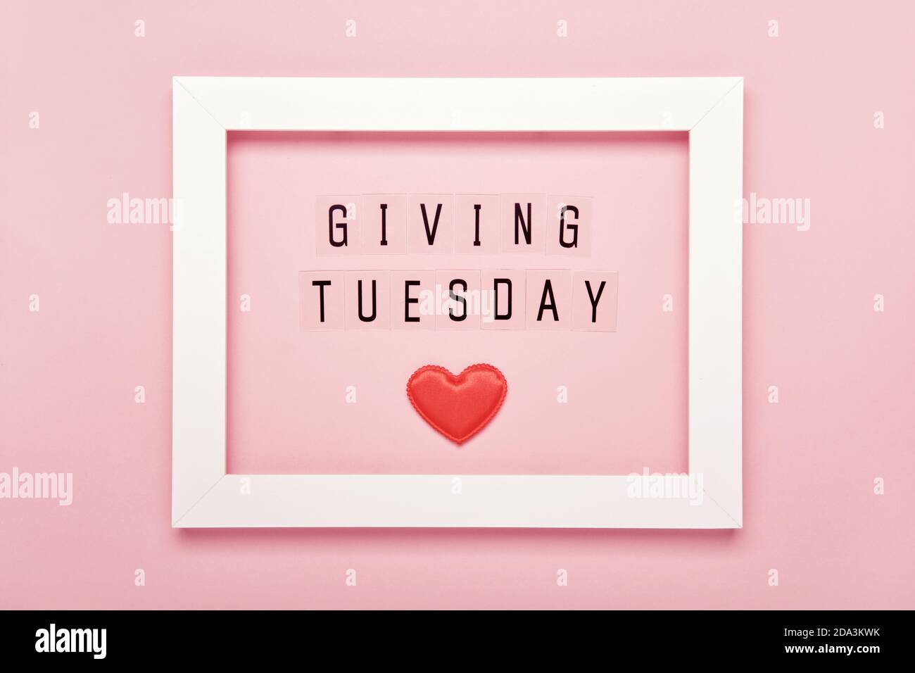 Giving Tuesday text message and Red hearts in white frame. Global day of charitable giving after Black Friday shopping day Stock Photo