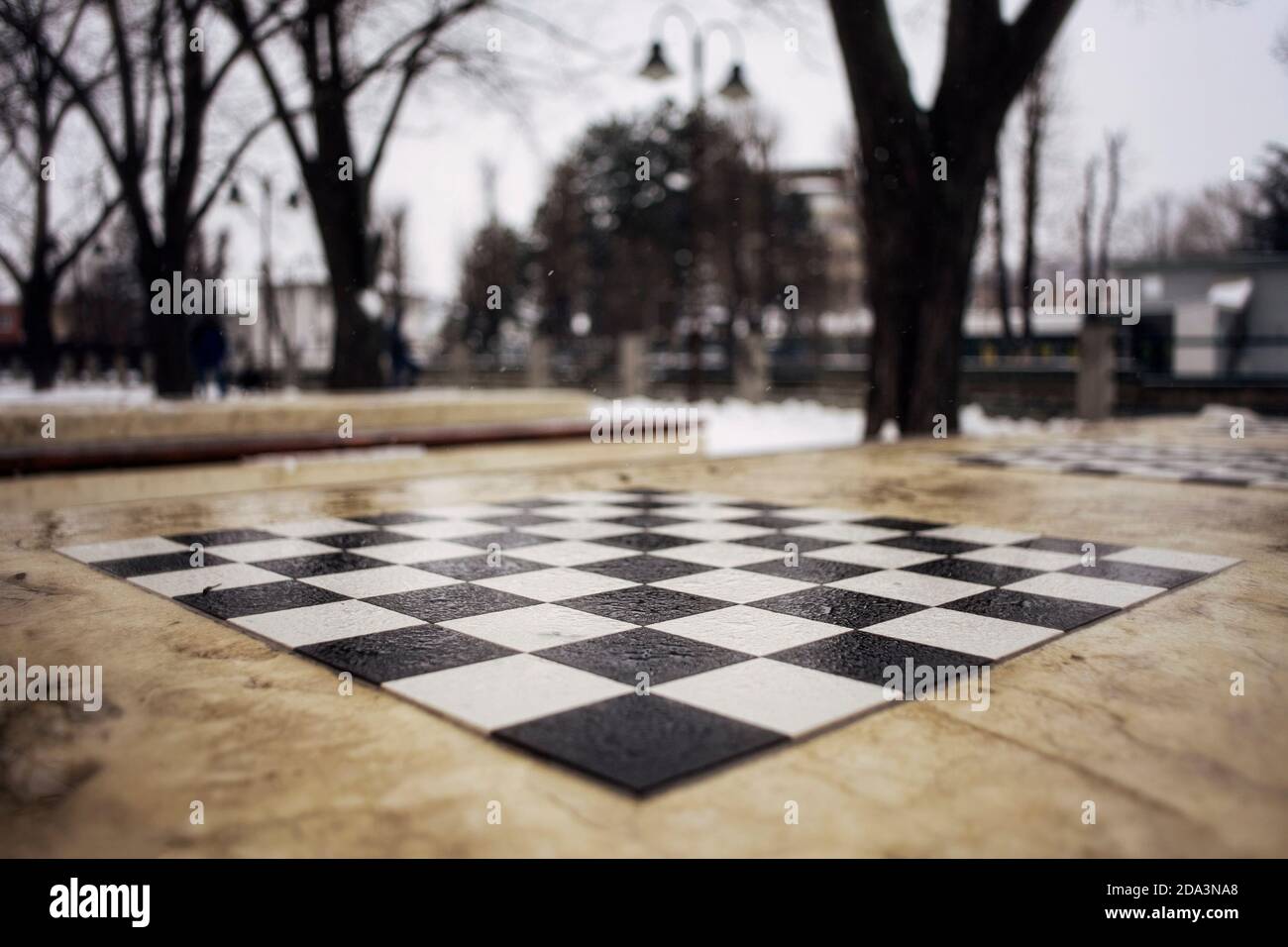Outdoor chess stone table on a cold winter day, close up. Stock Photo